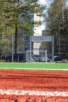 Soccer field with green grass and a treadmill close up