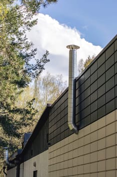 Pipe on the wall of a building in park