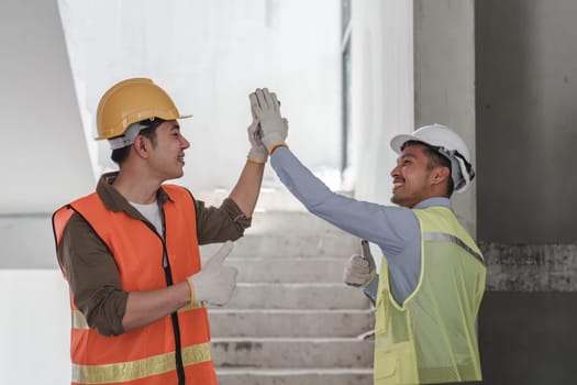 Businessman handshake with engineering in construction renovate building site. Engineer or architect inspection workplace for project.Teamwork construction engineer,business and architecture concept