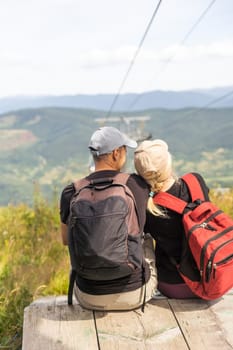 man and woman on the lift in the mountains