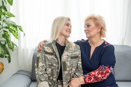 military woman and elderly mother at home.