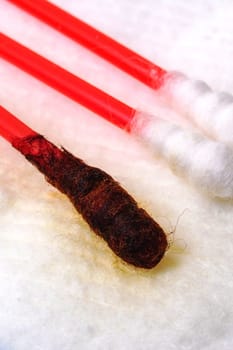 Cotton buds with medical iodine on a blue background