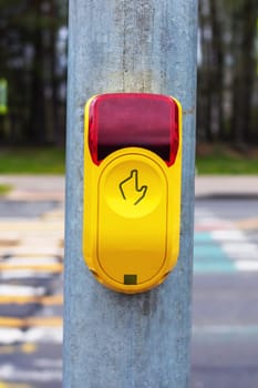 Traffic light button at a pedestrian crossing close up
