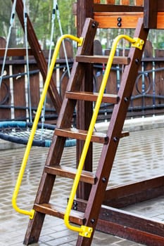 Wooden stairs in the playground wet in the rain