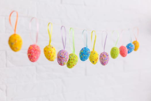 Easter eggs painted in pastel colors on a white background