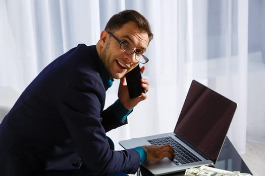 Business. Sucessful businessman working with laptop, using computer.