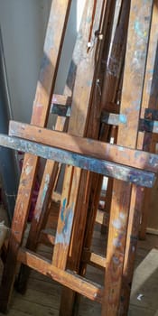 art easel with oil paint stains in art studio. High quality photo