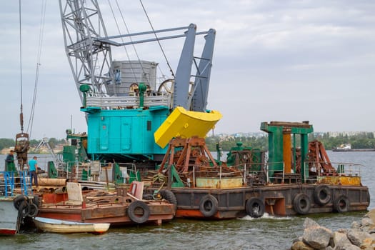 Luffing crane at the barge on water. High quality photo