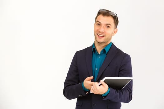 Smiling young man using tablet computer against a white background