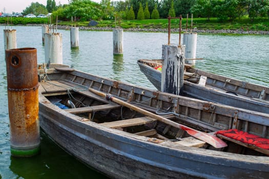 old wooden boats at the pier on green blooming water. High quality photo