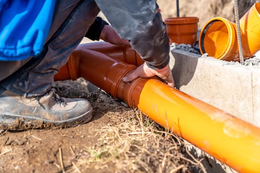 installation of a sewage plastic pipe during the construction of a house.