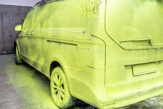 wash cars with green active foam in the garage. High quality photo
