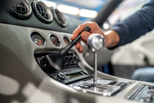 cleaning the interior of a luxury car with a brush. High quality photo