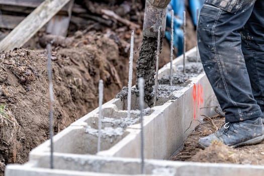 concreting from the pipe of the foundation of the building from the lost formwork.