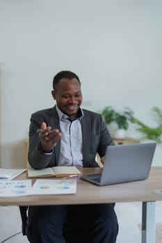 african american man, video call and laptop, wave hello and meeting, consulting or internet planning in startup company. Happy worker greeting for online meeting, computer webinar.