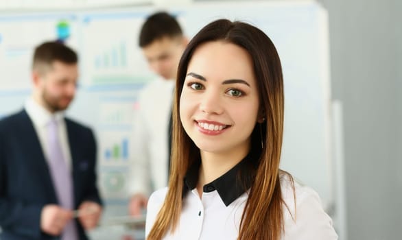 Portrait of smiling businesswoman in the background business partners. Successful career and internship in modern office