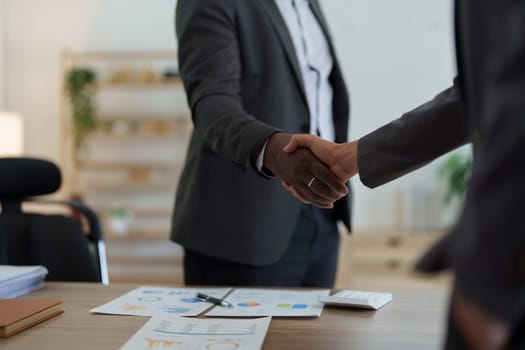 african american and asian people hand shaking successful corporate partnership deal welcoming opportunity in office agreement professional greeting meeting colleagues partners.