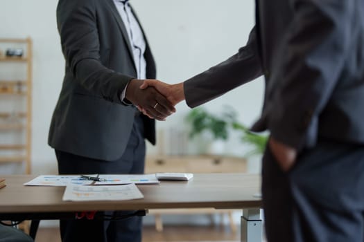 african american and asian people hand shaking successful corporate partnership deal welcoming opportunity in office agreement professional greeting meeting colleagues partners.