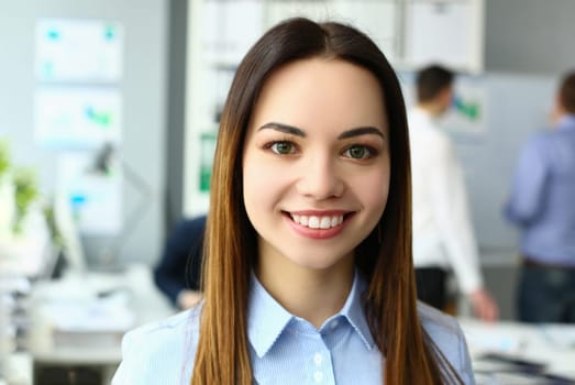 Portrait of beautiful joyful emotionally happy businesswoman in background of business colleague. Successful leadership career and internship in office