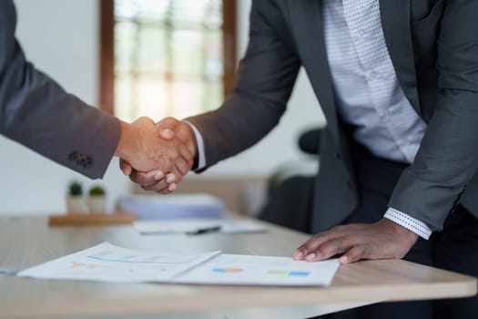 african american and asian people hand shaking successful corporate partnership deal welcoming opportunity in office agreement professional greeting meeting colleagues partners.