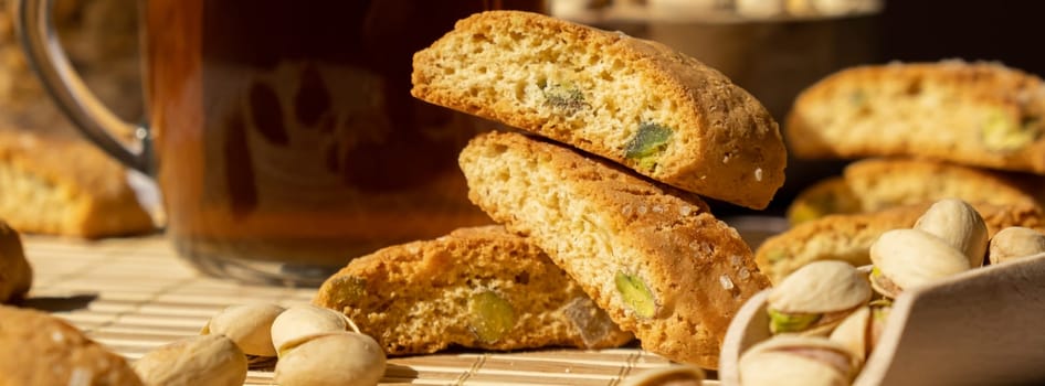 Biscotti Cantuccini Cookie Biscuits with pistachios and lemon peel Shortbread. Cup of tea. Teatime break Healthy eating food. Homemade fresh Italian cookies cantucci stacks and organic pistachios nuts. Vegan dieting vegetarian. Nutrition