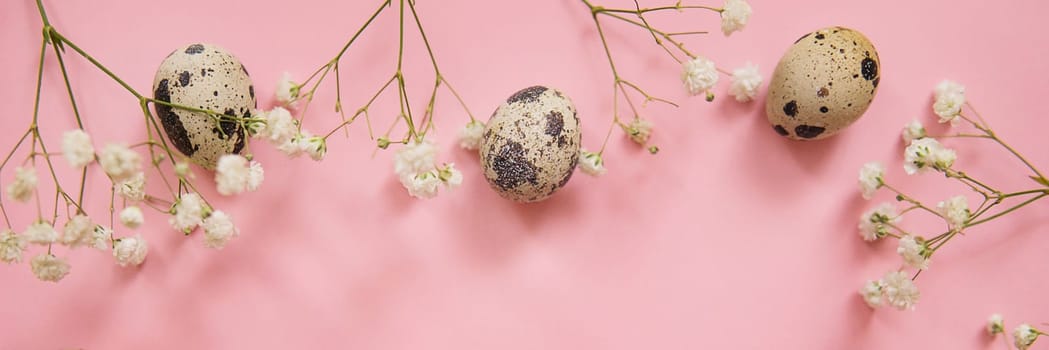 Easter background, quail eggs on a pink background, decorated with natural botanical elements, flat lay, view from above, empty space for text