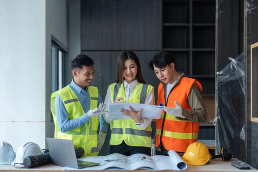 Team of engineer and architects working, meeting, discussing, designing, planning, measuring layout of building blueprints at construction site, Construction concept.