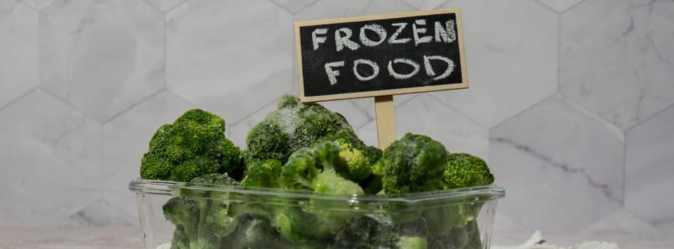 Frozen food broccoli florets with blackboard label and text FROZEN FOOD homemade. Harvesting concept. Stocking up vegetables for winter storage Healthy food, Cooking ingredients