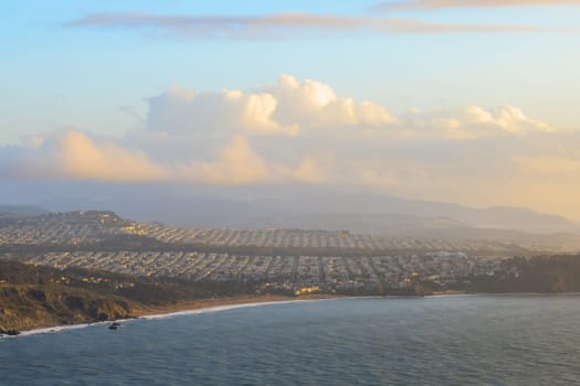 Sunset glow over rows of houses in residential area of coastal San Francisco. High quality photo