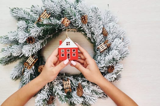 Woman's hands holds toys. Top view of christmas festive texture with new year decorations.