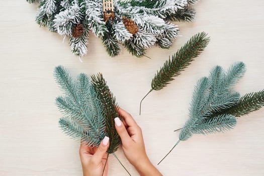 Woman's hands holds toys. Top view of christmas festive texture with new year decorations.