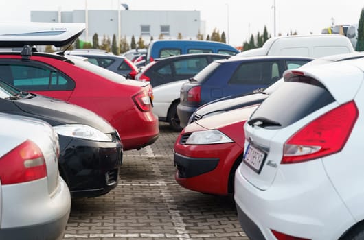 Poznan, Poland - January 24, 2023: cars parked in a row in an open parking lot.