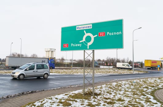 Poznan, Poland - January 24, 2023: There is a sign on a road junction indicating traffic to Poznan, Marianowo, Pneivy.