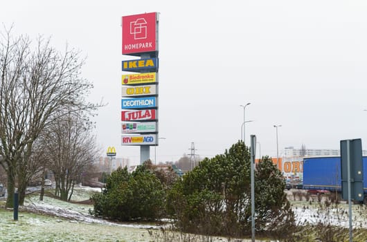 Poznan, Poland - January 25, 2023: Advertising pointer along the location of branded stores.