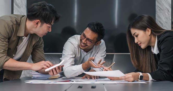 Business People Meeting using laptop computer,calculator,notebook,stock market chart paper for analysis Plans to improve quality next month. Conference Discussion Corporate Concept