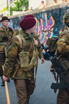 Hel, Poland - August 2022 Military troops marching during 3 May Polish Constitution Day ceremonial patriotic parade. Polish armed forces tanker military parade. Old guns and cars. Feast of Polish Armed Forces Day, American soldiers with US flag on parade Nato Vehicles Military Equipment