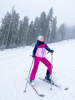 Shot of a skier woman on the ski slope resting relaxing extreme recreation active lifestyle activity. Female skier on a slope in the mountains. Winter active sport Country cross skier in Alps