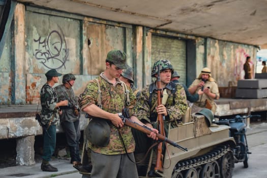 Hel, Poland - August 2022 Military troops marching during 3 May Polish Constitution Day ceremonial patriotic parade. Polish armed forces tanker military parade. Old guns and cars. Feast of Polish Armed Forces Day, American soldiers with US flag on parade Nato Vehicles Military Equipment