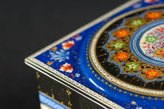 A closeup of a casket with an artistic painting on a black background. Central Asia, Uzbekistan