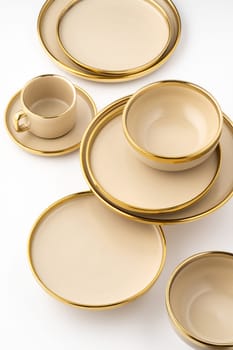 A Set of light brown ceramic plate and cup on a white background