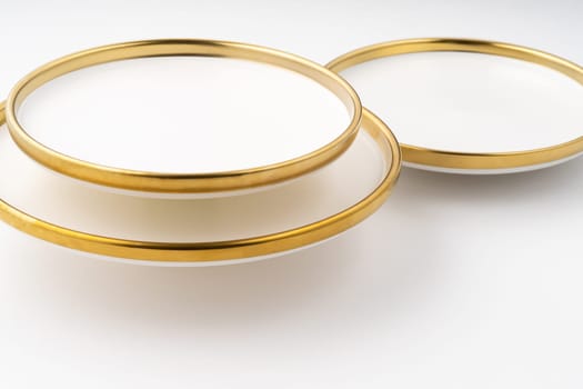 A set of white and brown ceramic plates on a white background