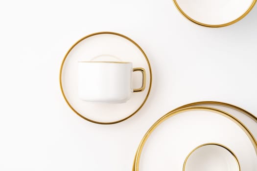 A set of white and brown ceramic plate and cup on a white background. Top view