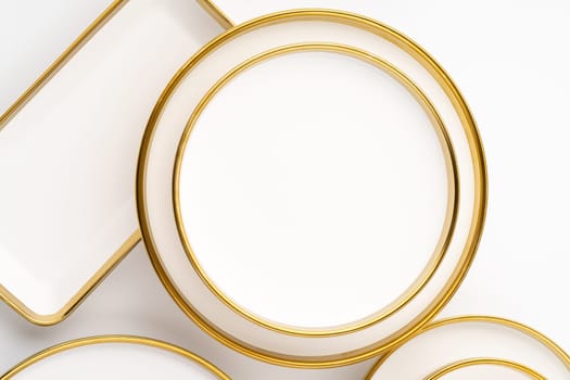 A set of white and brown ceramic plates on a white background. Top view