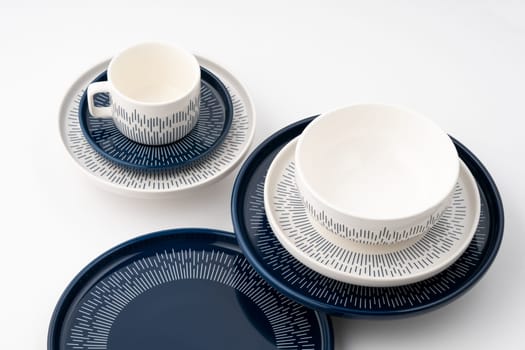 A set of blue and white luxury ceramic kitchen utensils on a white background