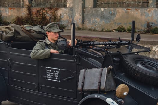 Hel, Poland - August 2022 Military troops marching during 3 May Polish Constitution Day ceremonial patriotic parade. Polish armed forces tanker military parade. Old guns and cars. Feast of Polish Armed Forces Day, American soldiers with US flag on parade Nato Vehicles Military Equipment