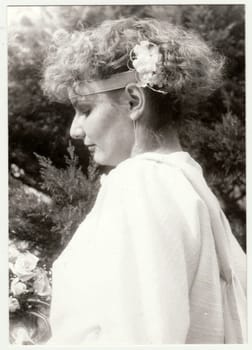 THE CZECHOSLOVAK SOCIALIST REPUBLIC - CIRCA 1980s: Vintage photo shows young woman with flowers in hair. Retro black and white photography.