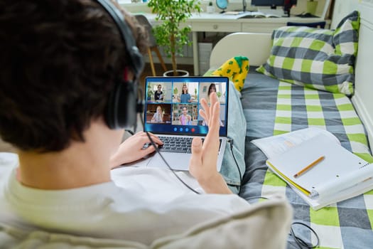 Video conference, teenage male student looking at laptop screen with group of teenagers studying remotely at home. Online lesson distance learning course. E-learning e-education technology high school