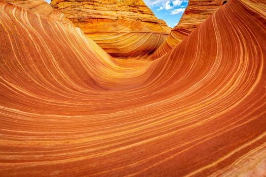 The Wave is a famous sandstone rock formation located in Coyote Buttes, Arizona, known for its colorful, undulating forms