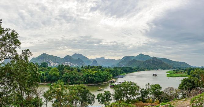 Panorama is views of the River Kwai and the mountains of Kanchanaburi Thailand.