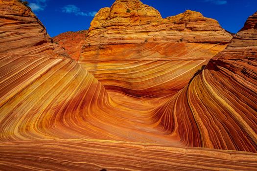 The Wave is a famous sandstone rock formation located in Coyote Buttes, Arizona, known for its colorful, undulating forms